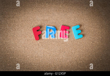 Colorful Wooden word FREE on cork board Stock Photo
