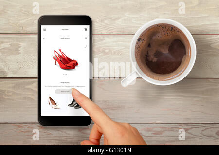 Woman shopping shoes with smart phone. Top view scene with coffee.