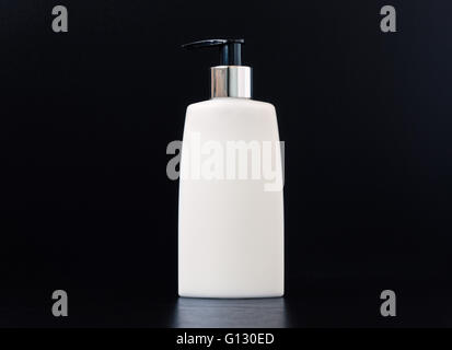 Skin exfoliation cream in a pump plastic bottle isolated on white. Stock Photo