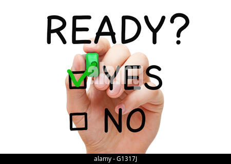 Hand putting check mark with green marker on Yes Ready. Readiness concept. Stock Photo