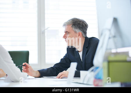 Elderly business man negotiating in meeting in the office Stock Photo