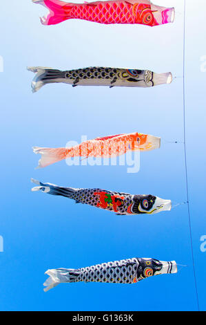Koinobori, or carp banners, flying against a clear blue sky. Stock Photo