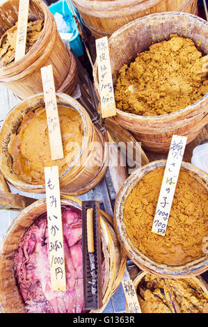 Pickled and preserved fish in wooden tubs on sale at Wajime morning market. Stock Photo