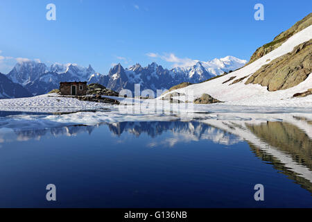 Lac Blanc alpine lake. View on Mont Blanc (Monte Bianco) mountain group.  Alpine bivouac of stones. French Alps. Europe. Stock Photo