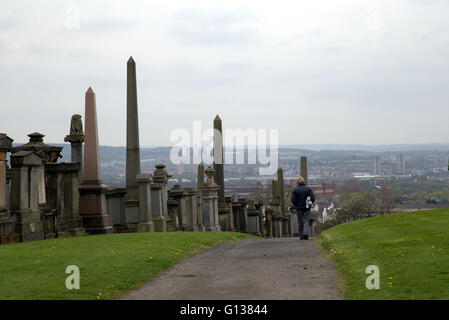 man walking in the necropolis of Glasgow with a view to the south of the city Glasgow, Scotland,U.K Stock Photo