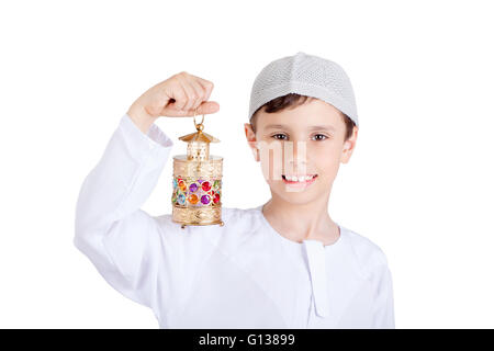 Happy Ramadan - Young Muslim kis smiling and holding Ramadan lantern Stock Photo