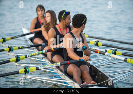 RIO DE JANEIRO - APRIL 2, 2016: A quadruple scull boat (with four rowers) compete in a race on Lagoa Rodrigo de Freitas lagoon. Stock Photo