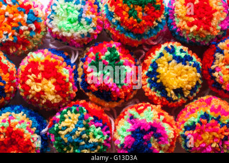 multicoloured home made poms poms made of brightly coloured wool  - pompoms pom poms pom-poms pompom pom-pom pom pom Stock Photo