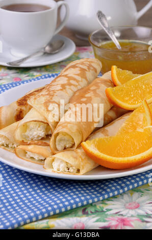 Pancakes stuffed with cottage cheese and oranges for breakfast Stock Photo