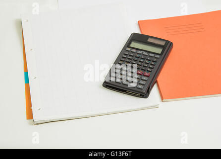 The concept of learning shown with a calculator on a background of graph paper Stock Photo