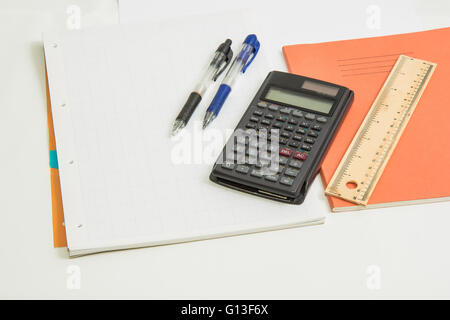 The concept of learning shown with a calculator & pens on a background of graph paper Stock Photo
