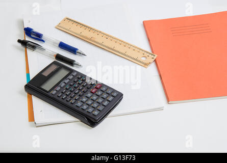 The concept of learning shown with a calculator & pens on a background of graph paper Stock Photo