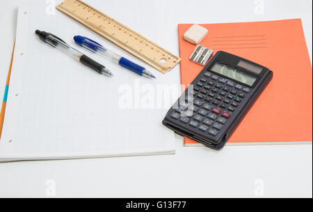 The concept of learning shown with a calculator & pens on a background of graph paper Stock Photo