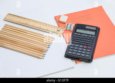 The concept of learning shown with a calculator & pencils on a background of graph paper Stock Photo
