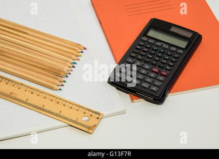 The concept of learning shown with a calculator & pencils on a background of graph paper Stock Photo