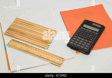 The concept of learning shown with a calculator & pencils on a background of graph paper Stock Photo