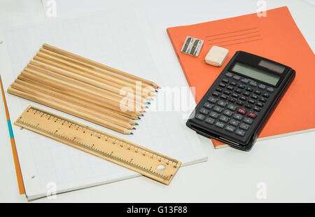 The concept of learning shown with a calculator & pencils on a background of graph paper Stock Photo
