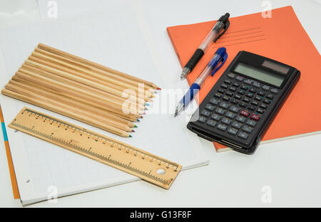 The concept of learning shown with a calculator & pens on a background of graph paper Stock Photo