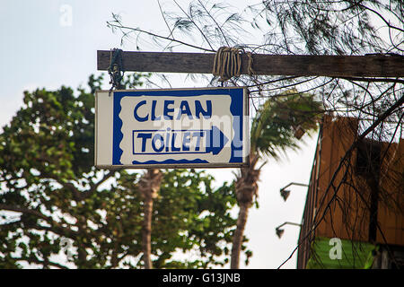 Close view of the old toilet sign hanging on the street Stock Photo