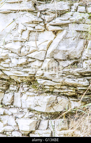 Close-up of wall made of white raw stone in daylight Stock Photo