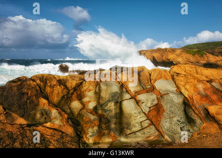 Mosaic patterns on the sandstone cliffs and crashing waves at Point Lobos State Natural Reserve and California’s Big Sur coast. Stock Photo