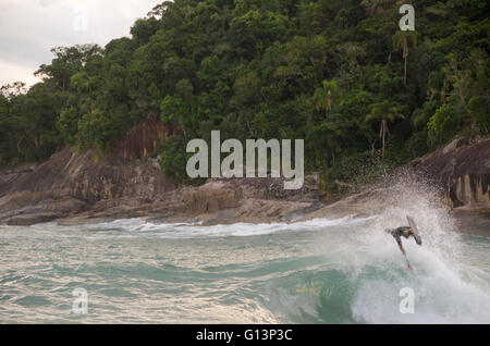 Ocean Wave Trick Roping Surfer performing trick on ocean wave Stock Photo - Alamy