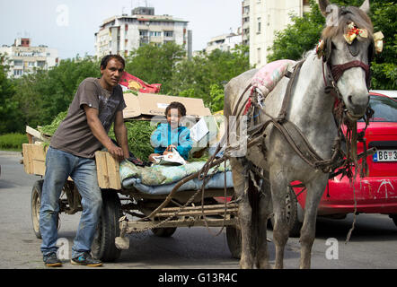 Belgrade, Serbia - Father and his little son gypsies posing with a horse-drawn carriage Stock Photo