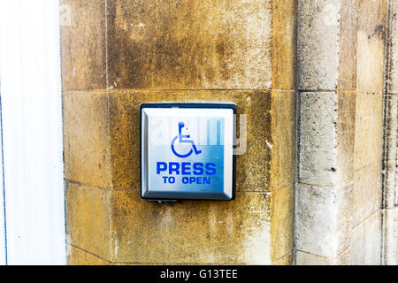 Disabled access button on wall press to open help assistance ease of accessibility wheelchair helping easing UK England Stock Photo
