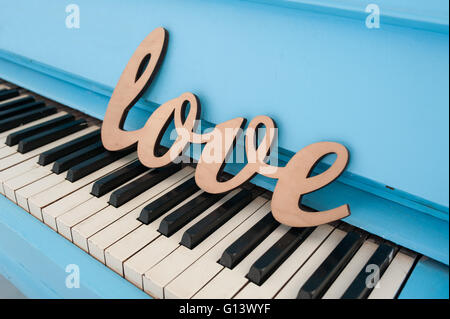 wooden word love on piano wedding concept Stock Photo