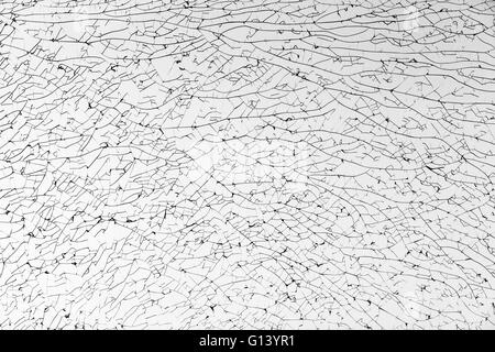 Broken glass with cracks pattern, monochrome background texture Stock Photo