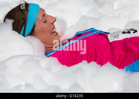 Poole, Dorset, UK. 8th May, 2016.  Foam Fest Dorset takes place at Baiter Park, Poole.  Runners dodge, dive, climb and laugh their way through a hilarious foam filled obstacle course for a 3k fun run organised by Naomi House and Jacksplace children’s hospices. Credit:  Carolyn Jenkins/Alamy Live News Stock Photo