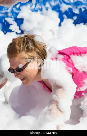 Poole, Dorset, UK. 8th May, 2016.  Foam Fest Dorset takes place at Baiter Park, Poole.  Runners dodge, dive, climb and laugh their way through a hilarious foam filled obstacle course for a 3k fun run organised by Naomi House and Jacksplace children’s hospices.  Credit:  Carolyn Jenkins/Alamy Live News Stock Photo