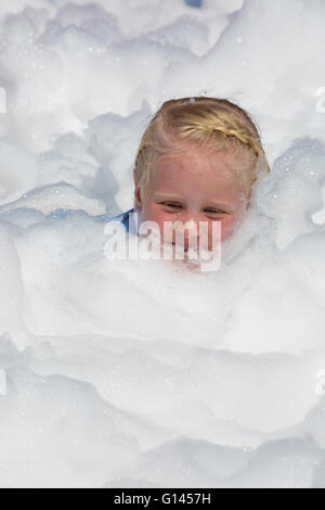 Poole, Dorset, UK. 8th May, 2016.  Foam Fest Dorset takes place at Baiter Park, Poole.  Runners dodge, dive, climb and laugh their way through a hilarious foam filled obstacle course for a 3k fun run organised by Naomi House and Jacksplace children’s hospices. Credit:  Carolyn Jenkins/Alamy Live News Stock Photo