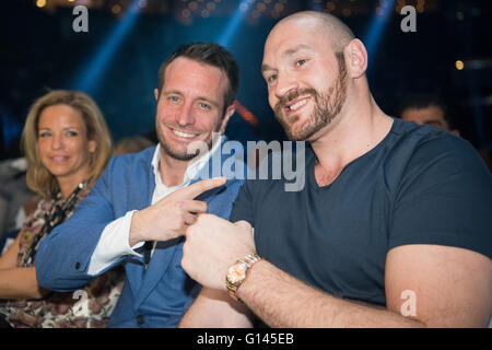 British world heavyweight boxing champion Tyson Fury (R) poses with German boxing promoter Karl-Robin 'Kalle' Sauerland (C) and Nathalie Sauerland (L) during the Global Boxing Union (GBU) Intercontinental Super Middleweight championship fight in the Barclaycard-Arena, Hamburg, Germany, 07 May 2016. Photo: LUKAS SCHULZE/dpa Stock Photo