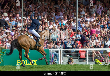 Badminton House, Badminton, UK. 08th May, 2016. Mitsubishi Motors Badminton Horse Trials. Day Five. Michael Jung (GER) riding &#x2018;La Biosthetique - Sam FBW' raises his arm in celebration in front of the full stand of spectators after winning The Mitsubishi Motors Badminton Horse Trails 2016. Credit:  Action Plus Sports/Alamy Live News Stock Photo