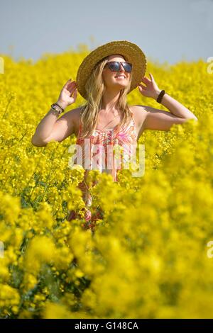 Dorset, UK. 8th May, 2016. One young woman has found how amazingly colourful the UK countryside can be at this special time of the year and when the sun shone today (Sun) even better! Laura Dean (26) pictured enjoying each of three vibrant and vivid displays located, within a few miles of her home at Weymouth, Dorset. The 5acre carpet of, Sea Pinks (Thrift) are next to the 18mile long Chesil Beach, one of the largest such areas of the plants in the UK.  Credit:  Dorset Media Service/Alamy Live News Stock Photo