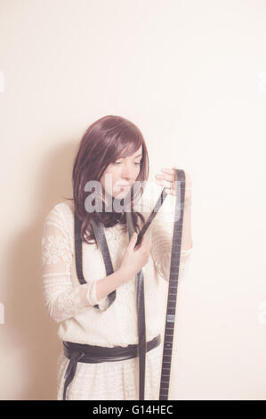 Young actress in 70s style portrait with filmstrip old vintage image effect Stock Photo