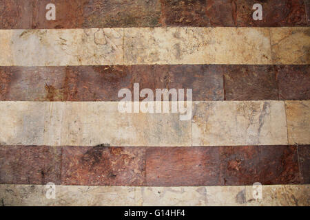 Old grunge red and white striped marble wall background texture in the Old City of Jerusalem, Israel. Stock Photo