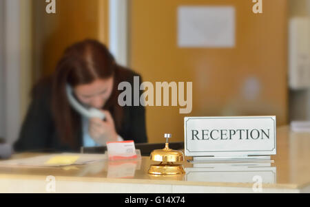hotel reception counter desk with bell Stock Photo