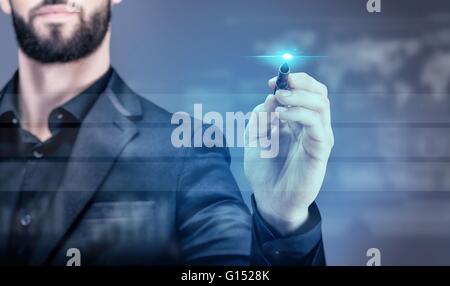 Young business man writing on a virtual screen Stock Photo