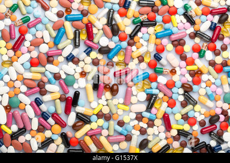 Scattered colorful medical pills and drugs Stock Photo