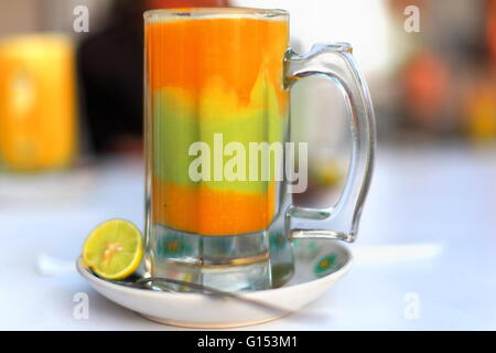 Jug full of multifruit -mango-kiwi-orange-papaya- juice on a table in the terrace of the Hikma Pension Hotel. Kombolcha-Ethiopia Stock Photo