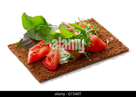 Bread crisp (crispbread open-faced sandwich) with heirloom tomato, soft cream cheese and arugula salad. Clipping paths for both  Stock Photo