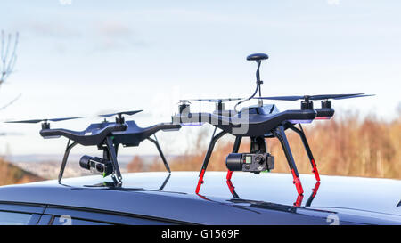 Drones ready to be deployed from the roof of a parked car. Stock Photo