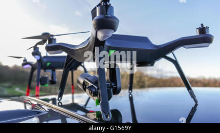 Drones ready to be deployed from the roof of a parked car. Stock Photo