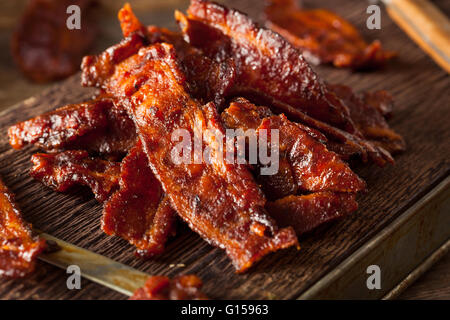 Homemade Dried Barbecue Bacon Jerky with Salt Stock Photo