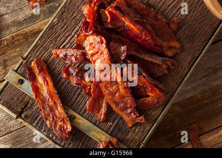 Homemade Dried Barbecue Bacon Jerky with Salt Stock Photo
