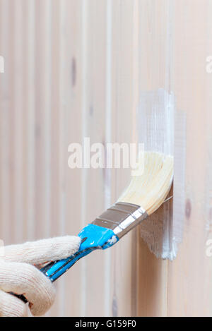 covering protective impregnating wooden wall, close-up shot Stock Photo