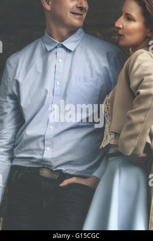 young couple standing close to each other and talking Stock Photo