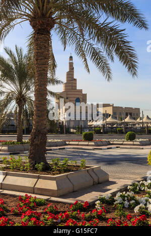 Palm trees and flower beds along Al-Corniche, waterfront promenade, with Qatar Islamic Cultural Centre, Doha, Qatar, Middle East Stock Photo
